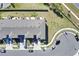 Aerial view of townhomes with private garages, lush lawns, and convenient street parking in a well-planned community at 4544 Teoli Ct, Kissimmee, FL 34746