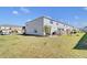 Large backyard with green grass and patio with grill, ideal for outdoor entertaining at 4544 Teoli Ct, Kissimmee, FL 34746