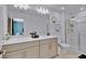 Bathroom with double vanity, framed mirrors, and walk-in shower at 4544 Teoli Ct, Kissimmee, FL 34746