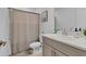 Bathroom with neutral tones and a bathtub with a shower curtain at 4544 Teoli Ct, Kissimmee, FL 34746