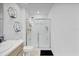 Bright bathroom with a shower, modern fixtures, and stylish geometric wall decor at 4544 Teoli Ct, Kissimmee, FL 34746