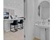 Bathroom with sink and mirror adjacent to kitchen with modern countertops and bar stools at 4544 Teoli Ct, Kissimmee, FL 34746