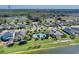 Aerial view of a serene residential neighborhood with a pool, community center, and lush greenery near a tranquil lake at 4544 Teoli Ct, Kissimmee, FL 34746