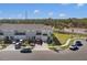 Exterior view of well-maintained townhomes with garages, neat landscaping, and ample parking in a suburban setting at 4544 Teoli Ct, Kissimmee, FL 34746