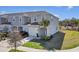 Charming two-story townhouse featuring an attached garage, well-maintained landscaping, and a welcoming front entrance at 4544 Teoli Ct, Kissimmee, FL 34746