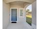 Charming front entrance with a light blue door, white trim, and a welcoming covered porch at 4544 Teoli Ct, Kissimmee, FL 34746