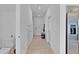 Bright hallway leads to various rooms, stainless steel refrigerator on the right at 4544 Teoli Ct, Kissimmee, FL 34746