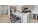 Bright kitchen with stainless steel appliances and a large island with bar stool seating at 4544 Teoli Ct, Kissimmee, FL 34746