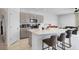 Kitchen with a large island with a waterfall countertop and bar stool seating at 4544 Teoli Ct, Kissimmee, FL 34746