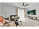 Bright living room with large TV and sliding glass doors leading to patio at 4544 Teoli Ct, Kissimmee, FL 34746