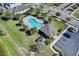 Aerial view of the community pool, surrounded by palm trees and lounge chairs at 4544 Teoli Ct, Kissimmee, FL 34746