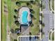 Aerial view of a community pool complete with lounge seating, a charming cabana, and convenient parking facilities at 4544 Teoli Ct, Kissimmee, FL 34746