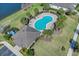 Aerial image of a community pool surrounded by lush landscaping, lounge chairs, and a nearby cabana for residents at 4544 Teoli Ct, Kissimmee, FL 34746