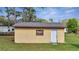 Exterior of matching shed with a white door and window, set in the backyard at 4980 Satellite Ave, St Cloud, FL 34773