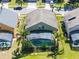 Aerial view of a screened-in pool, nestled between well-maintained lawns and neighboring homes within outlined property lines at 509 Cadiz Loop, Davenport, FL 33837