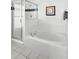 Bright bathroom features a glass-door shower and large white soaking tub at 509 Cadiz Loop, Davenport, FL 33837