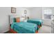 Bright bedroom featuring two beds with colorful bedding and decor at 509 Cadiz Loop, Davenport, FL 33837