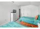 Bedroom featuring two beds with colorful bedding, a dresser with a TV, and an ensuite bathroom at 509 Cadiz Loop, Davenport, FL 33837