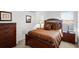 Cozy bedroom features elegant dark wood furnishings, a comfortable bed, and ample natural light at 509 Cadiz Loop, Davenport, FL 33837