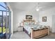Bedroom featuring a comfortable bed, ceiling fan, and sliding doors to an outdoor patio at 509 Cadiz Loop, Davenport, FL 33837