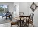 Elegant dining area with seating for six, featuring stylish chairs, a decorative mirror and seamless access to outdoor views at 509 Cadiz Loop, Davenport, FL 33837