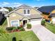 Charming single-Gathering home with a well-manicured lawn and a paved driveway leading to a two-car garage at 509 Cadiz Loop, Davenport, FL 33837