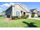 A house with meticulous landscaping, showcasing lush greenery and well-maintained lawn at 509 Cadiz Loop, Davenport, FL 33837