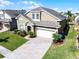 Two-story home boasts a well-maintained lawn and a two-car garage at 509 Cadiz Loop, Davenport, FL 33837