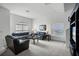 Bright living room features plush carpeting, large windows with blinds, and comfortable seating arrangements at 509 Cadiz Loop, Davenport, FL 33837