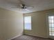 Bright bedroom with a ceiling fan, neutral carpet, and a window to let in natural light at 5160 Conroy Rd # 1414, Orlando, FL 32811