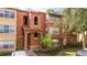 Exterior view of the building showing private entrance, balcony and mature landscaping at 5160 Conroy Rd # 1414, Orlando, FL 32811