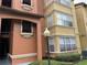 Multi-story building with unique architectural details, decorative windows, and lush landscaping at 5160 Conroy Rd # 1414, Orlando, FL 32811