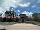 A large, attractive clubhouse featuring a circular tower entry, well-manicured landscaping, and ample parking at 5160 Conroy Rd # 1414, Orlando, FL 32811