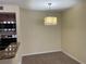 Open-concept dining area with modern lighting fixture, and convenient kitchen access at 5160 Conroy Rd # 1414, Orlando, FL 32811