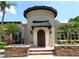 Elegant entrance with a round turret, dark wood door, and landscaped surroundings at 5160 Conroy Rd # 1414, Orlando, FL 32811