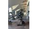 A spacious gym featuring modern exercise equipment, large windows, and mirrored walls at 5160 Conroy Rd # 1414, Orlando, FL 32811