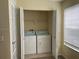 Bright laundry area with washer, dryer, and folding doors in closet at 5160 Conroy Rd # 1414, Orlando, FL 32811