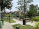 Community picnic area with charcoal grill and well maintained landscaping and grass at 5160 Conroy Rd # 1414, Orlando, FL 32811