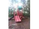 Community playground with slides and climbing structure surrounded by mature trees at 5160 Conroy Rd # 1414, Orlando, FL 32811