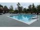 Community pool with lounge chairs and meticulously landscaped surroundings at 5160 Conroy Rd # 1414, Orlando, FL 32811