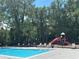 Relaxing pool area with lounge chairs, next to a vibrant playground with slide for Gathering fun at 5160 Conroy Rd # 1414, Orlando, FL 32811