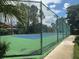 Well-maintained tennis court enclosed by a tall fence for privacy and security at 5160 Conroy Rd # 1414, Orlando, FL 32811