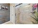 Bathroom featuring frameless glass shower with light beige tile, along with decorative wall accents at 5457 Animosh Ct, Polk City, FL 33868