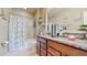 Bright bathroom featuring granite countertops, tile floors, and a tub with shower at 5457 Animosh Ct, Polk City, FL 33868