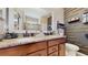 Bathroom showcasing double sinks with granite countertops, decorative wall accents, and a toilet at 5457 Animosh Ct, Polk City, FL 33868