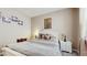 Comfortable bedroom boasting a bright window, neutral decor and a bed with decorative pillows at 5457 Animosh Ct, Polk City, FL 33868