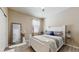 This bedroom boasts a spacious layout with a bright window and a large decorative mirror at 5457 Animosh Ct, Polk City, FL 33868
