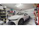 Spacious garage featuring a white car, ample storage, and organized shelves at 5457 Animosh Ct, Polk City, FL 33868