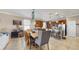Spacious kitchen and dining area with stainless steel appliances and a large wooden dining table at 5457 Animosh Ct, Polk City, FL 33868