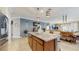 A kitchen island featuring granite countertops and pendant lighting, creating an inviting atmosphere at 5457 Animosh Ct, Polk City, FL 33868